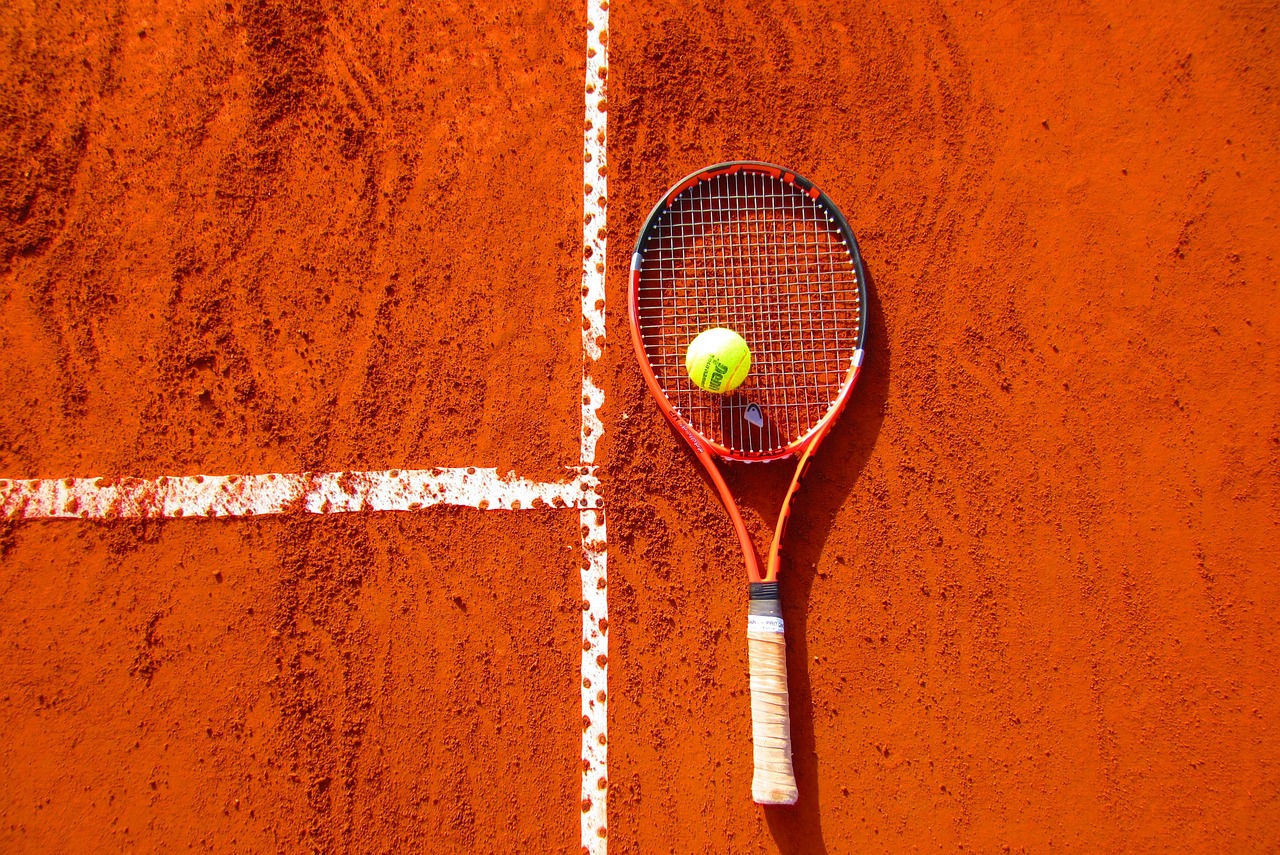 Tennis racket on clay tennis court