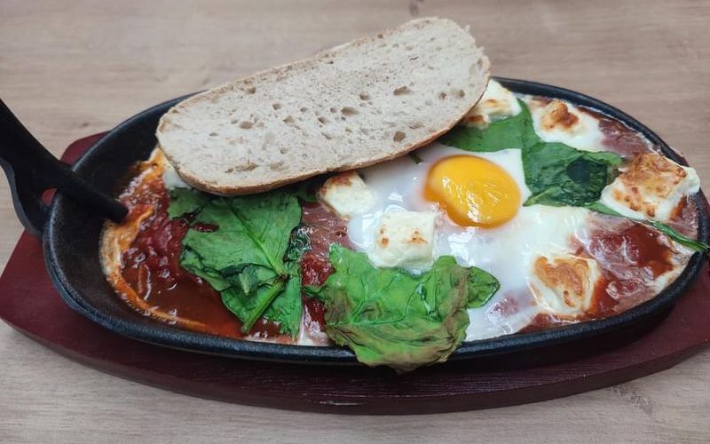 Shakshuka at the Ron Cooke cafe. Tomato and onion topped with egg, feta, spinach and bread