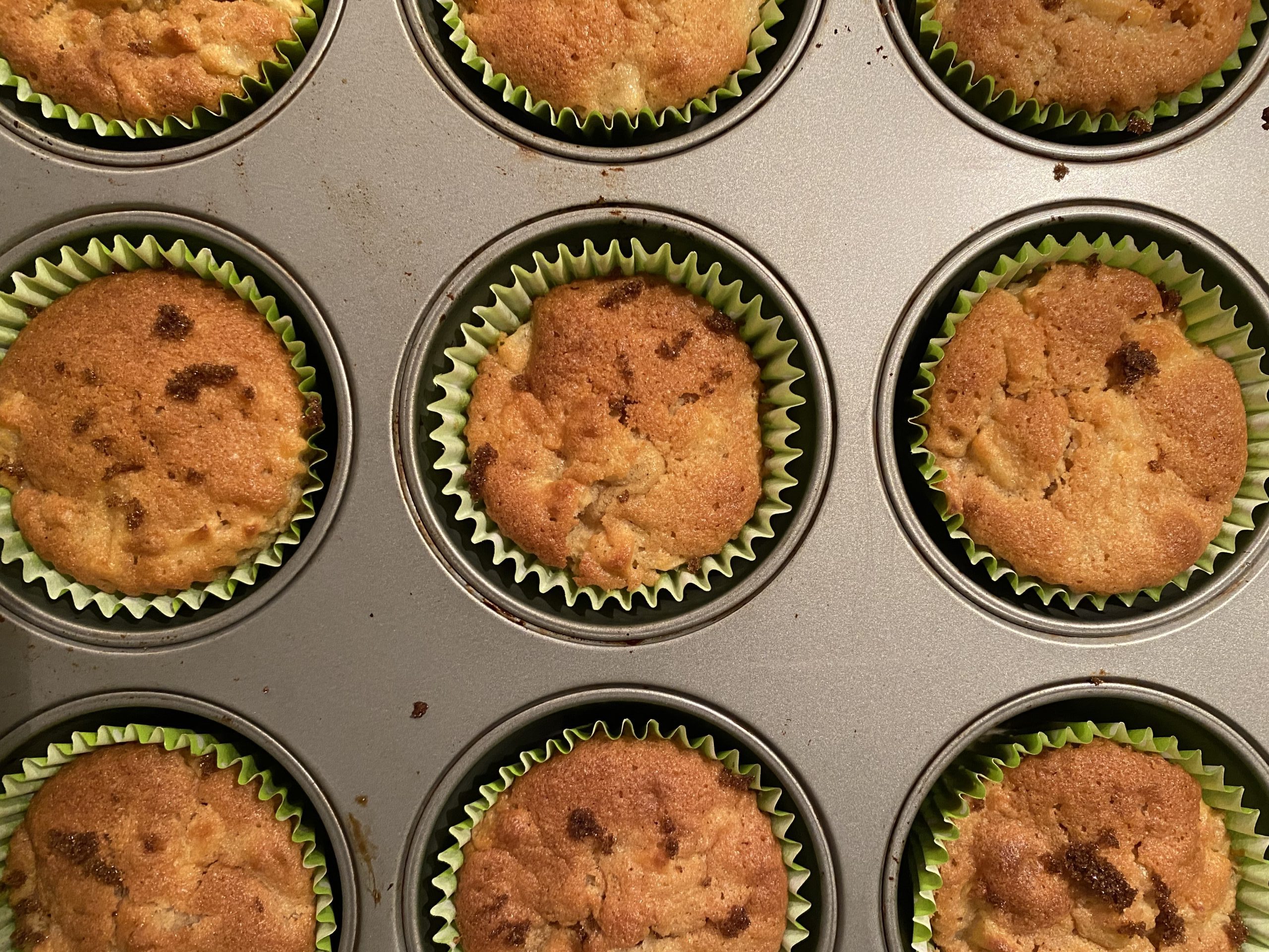 Spiced apple muffins in baking tray