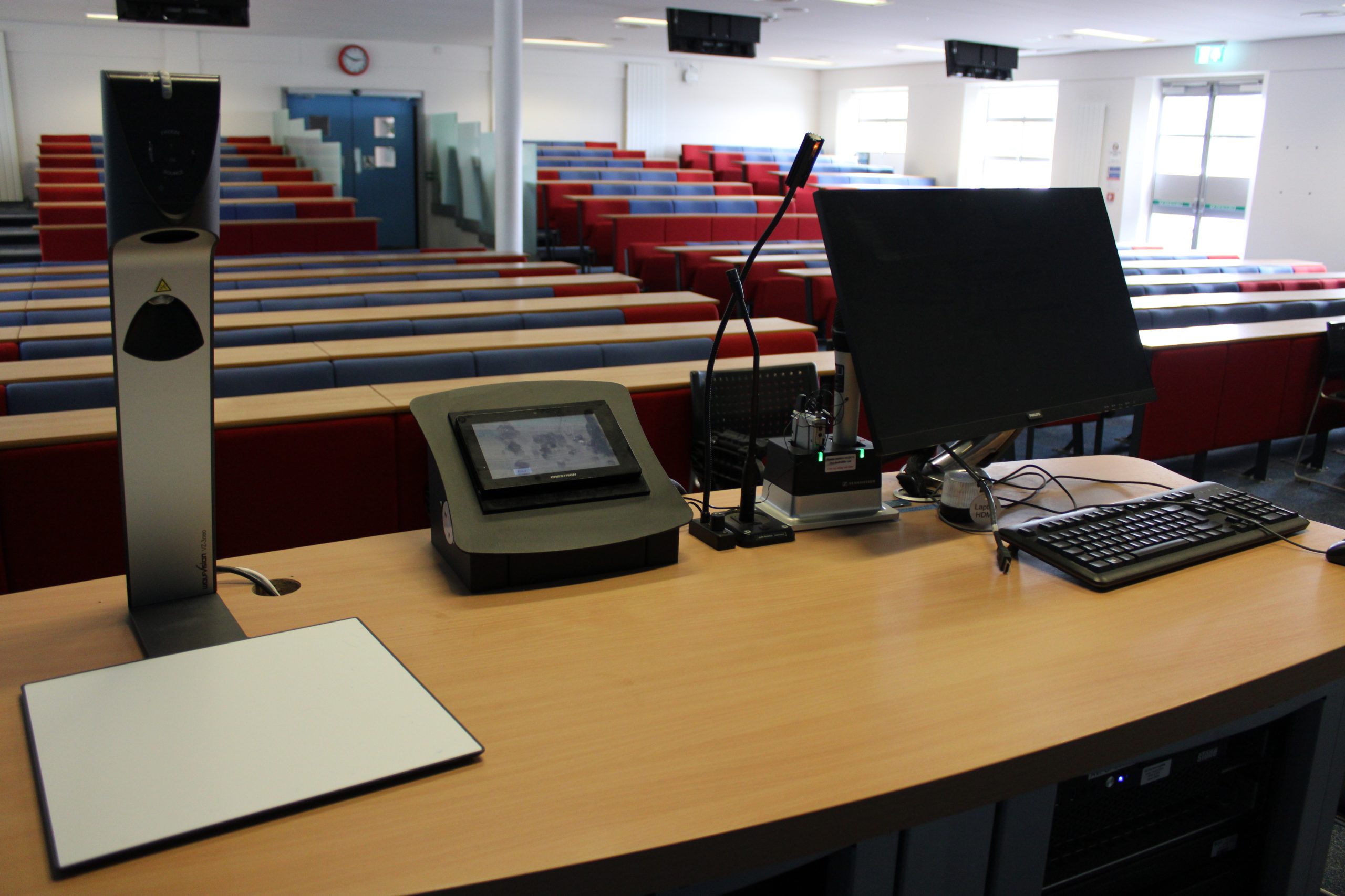 Lecture Desk view with computer looking out onto empty chairs