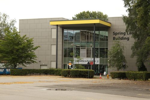 Spring Lane Building outside view with tree foliage on the left