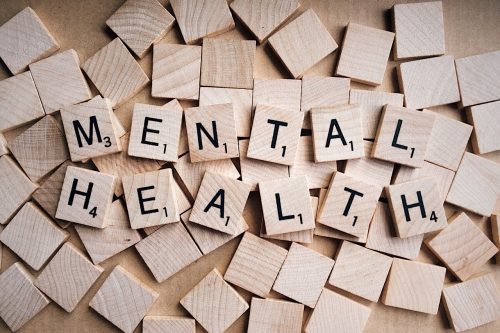 The letters 'Mental Health' spelt out in wooden blocks