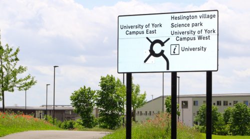 Road sign with grass in the background