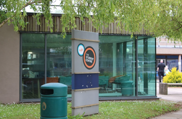 Student Union Building at the University of York with a glass building and green tree in the background