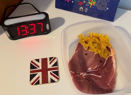 Piece of gammon next to a clock and a union jack coaster