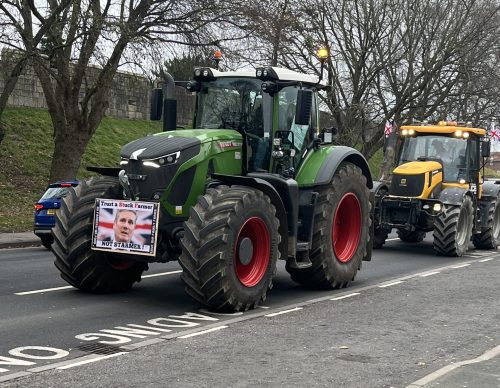 Tractor with a sign saying 'trust a Stucker Farmer not Starmer'