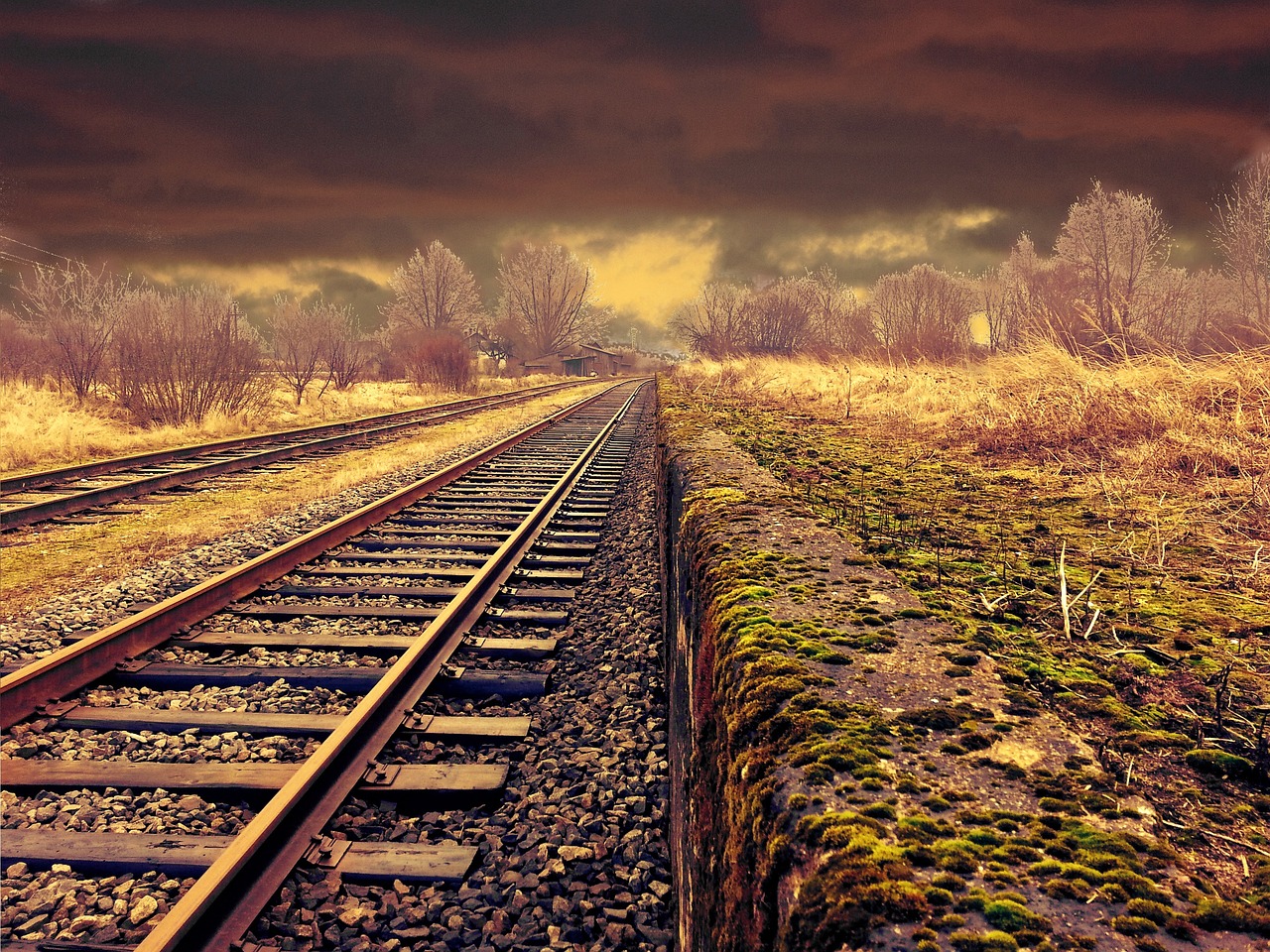 Railway tracks with a yellow sunset background