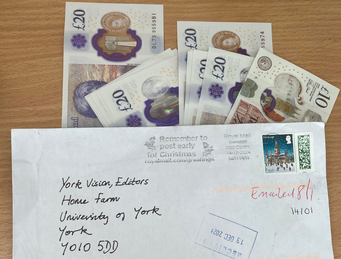 Envelope with several cash notes displayed in the background